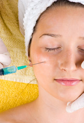 A woman receiving a Botox® injection in her face