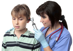 A doctor performing an ear exam on a child