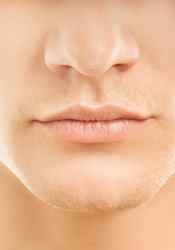 A close up of a male's nasal area of the face