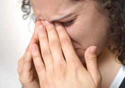A woman suffering from severe sinus pain