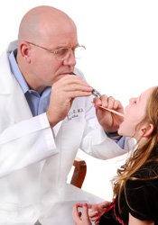 A doctor checking a child's tonsils
